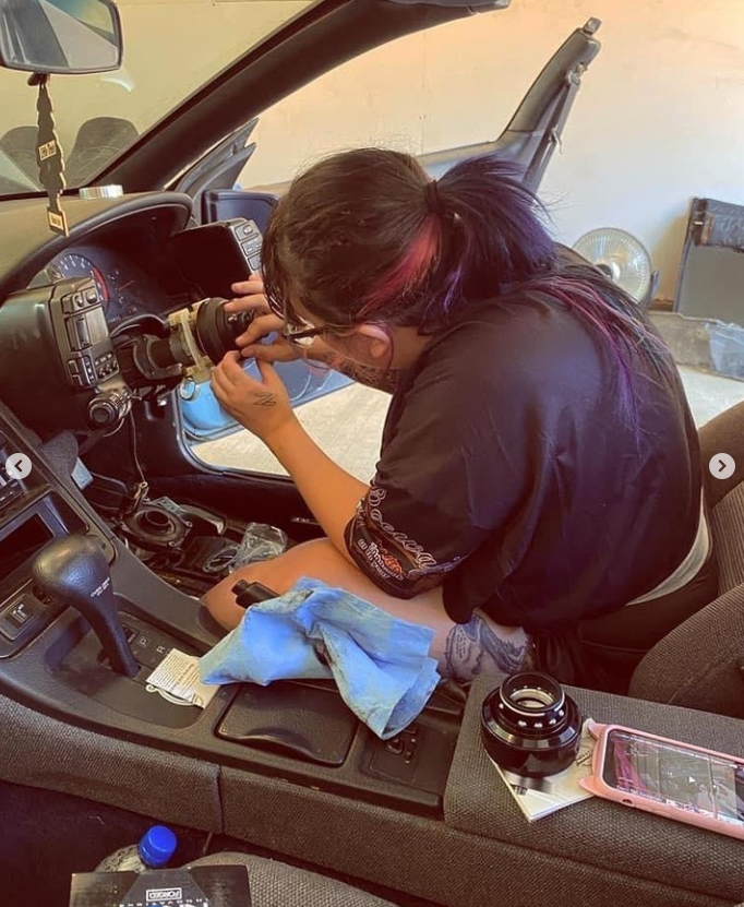 A team member completing detailed work inside a vehicle