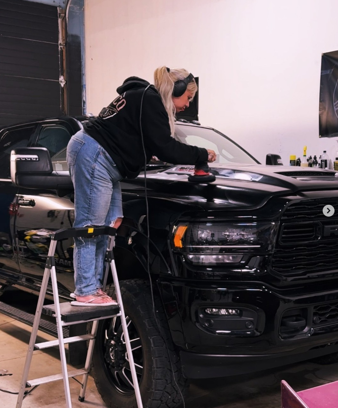 Kay machine polishing the hood of a black RAM truck