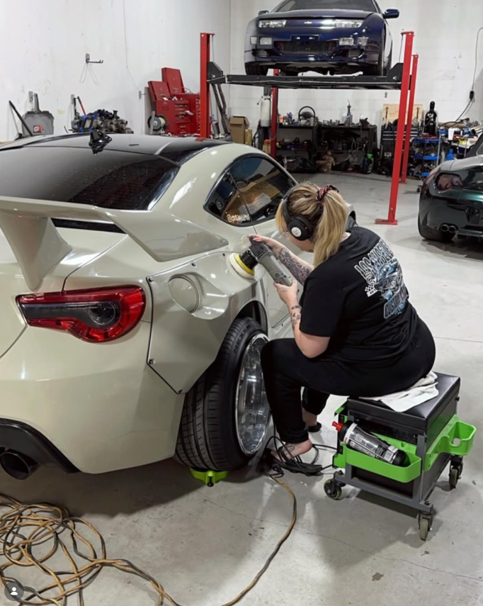 Kay machine polishing the rear quarter of a modified sports coupe